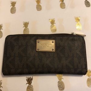 Michael Kors signature logo zip around wallet.